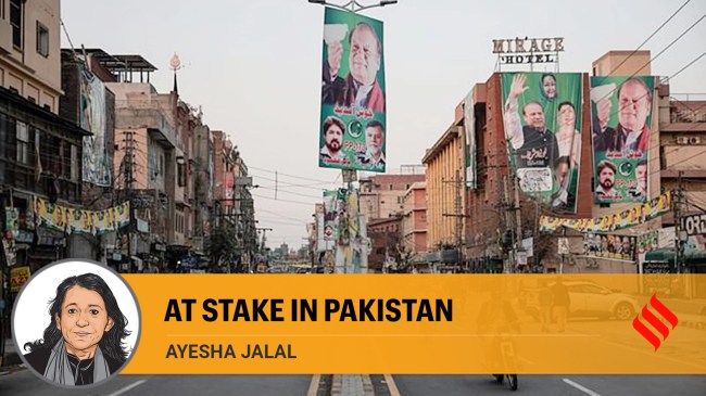 People commute on a street filled with campaign banners and posters of a political party, ahead of the general elections, in Lahore. (Reuters)