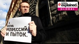 Opposition leader Alexei Navalny holds a placard reading "I'm against repression and torture" during a protest march in Moscow