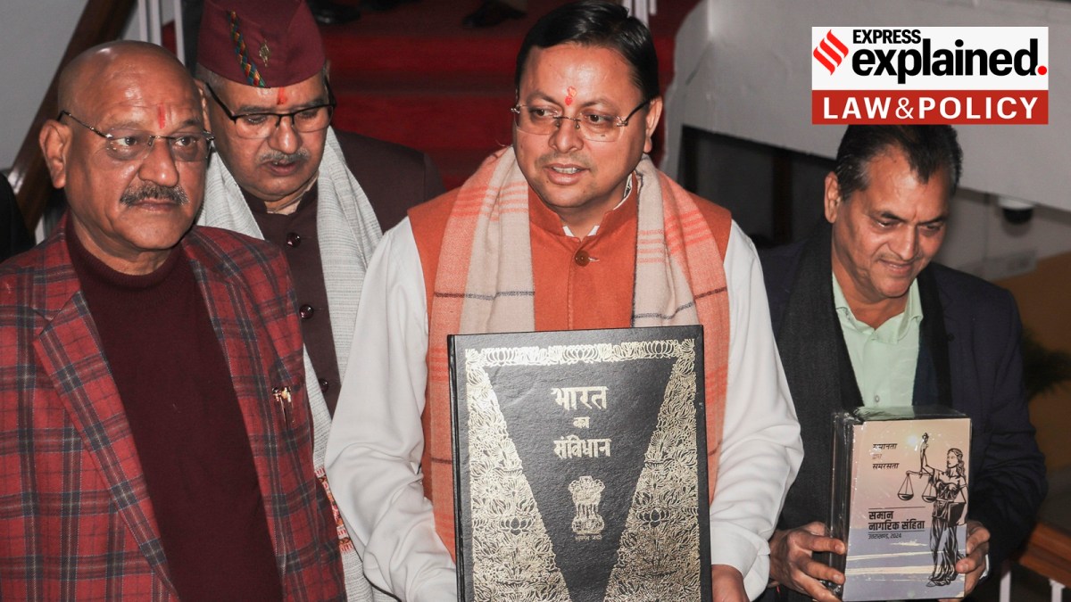 Uttarakhand Chief Minister Pushkar Singh Dhami, with others, holds a copy of the Constitution of India, at Vidhan Sabha Bhawan, in Dehradun, Tuesday, Feb. 6, 2024.