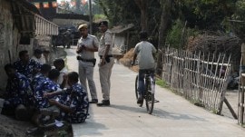 Security outside TMC leader Haladhar Ari’s house in Sandeshkhali. (Express photo by Partha Paul)