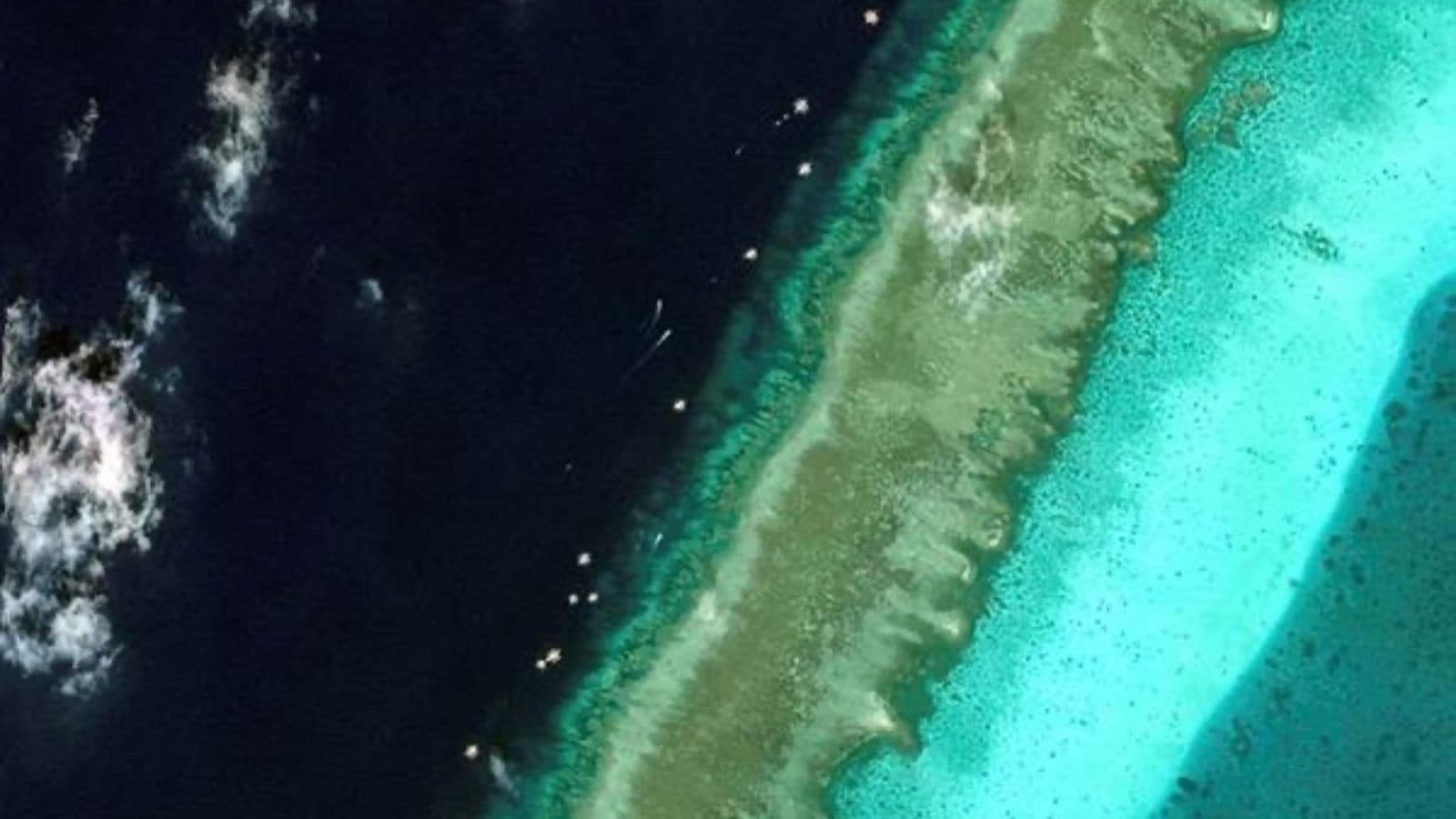 Satellite images reveal floating barrier at mouth of disputed atoll in South China Sea