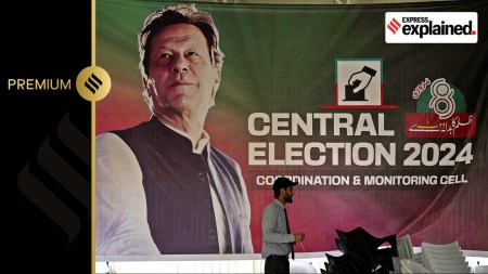 A supporter walks past a poster of imprisoned leader Pakistan's Former Prime Minister Imran Khan display at his party office, in Islamabad, Pakistan, Friday, Feb. 9, 2024.