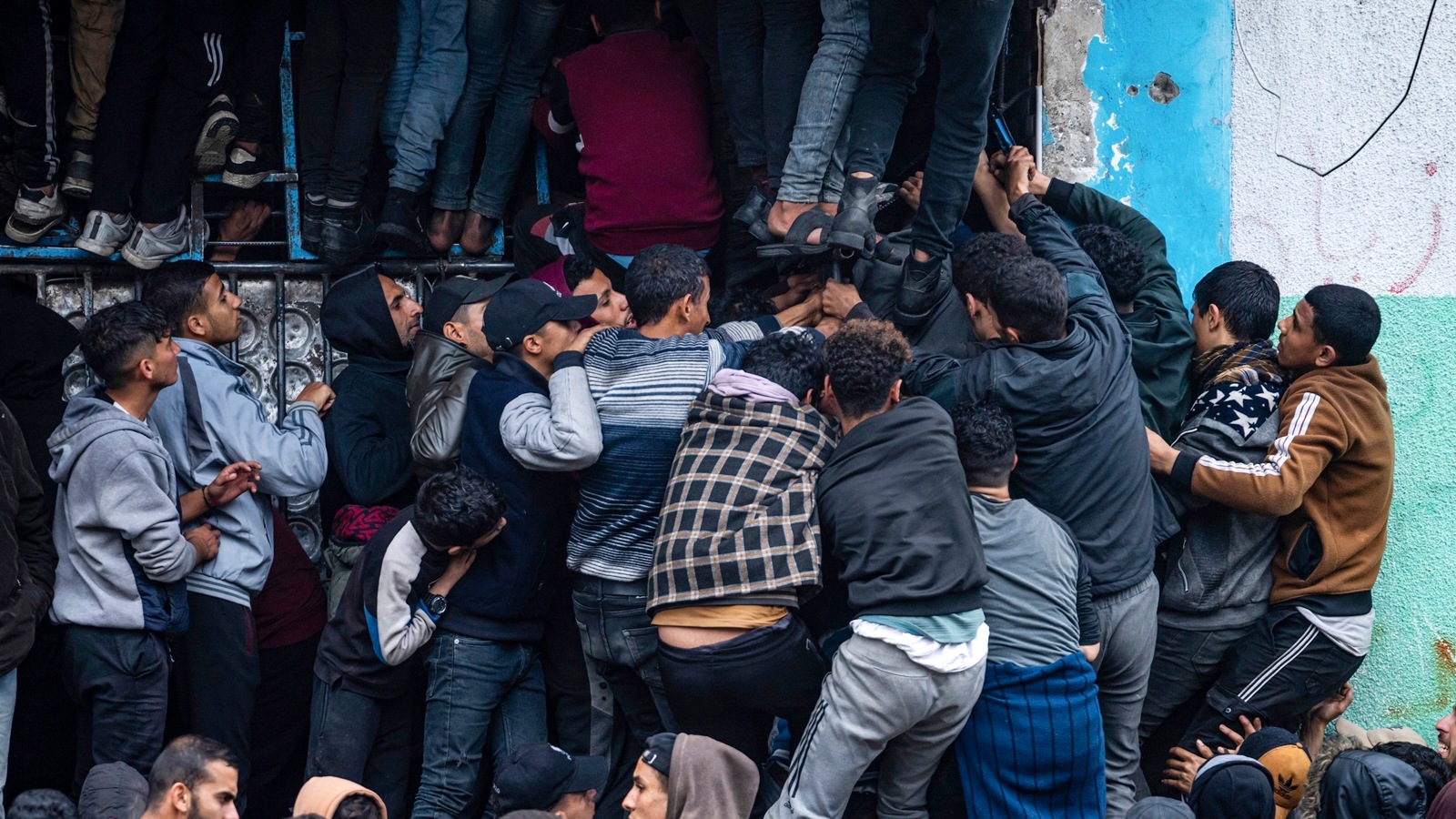 Palestinian crowds struggle to buy bread from a bakery in Rafah, Gaza Strip, Sunday, Feb. 18, 2024. International aid agencies say Gaza is suffering from shortages of food, medicine and other basic supplies as a result of the war between Israel and Hamas. AP/PTI(AP02_18_2024_000276A)
