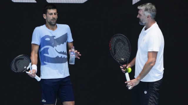 Serbia's Novak Djokovic, left, gestures as talks with coach Goran Ivanisevic during a practice session ahead of the Australian Open