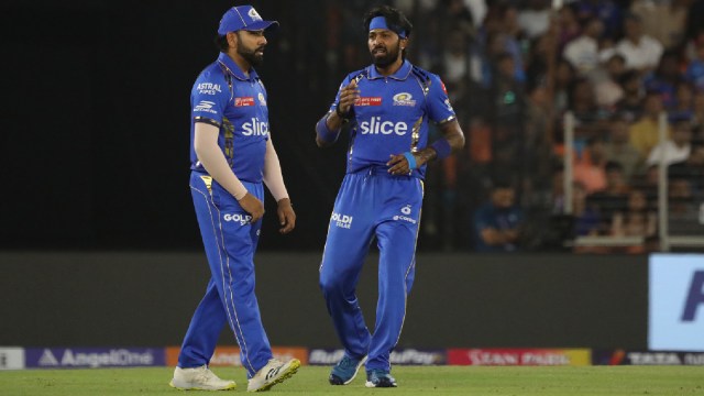 Mumbai Indians captain Hardik Pandya interacting with Rohit Sharma during IPL Cricket match between Mumbai Indians and Gujarat Titans at Narendra Modi stadium in Ahmedabad on Sunday Express photo by Nirmal Harindran