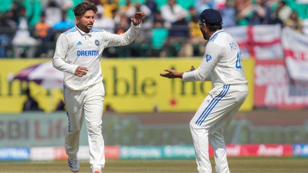 India's bowler Kuldeep Yadav with captain Rohit Sharma celebrates the wicket of England's batter Ben Stokes during the first day of the fifth Test cricket match between India and England, in Dharamshala