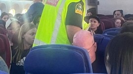 A paramedic walks onboard as passengers look on, after an incident on a LATAM Airlines Boeing 787, in Auckland, New Zealand, March 11, 2024, in this picture obtained from social media. (Brian Adam Jokat/via Reuters)