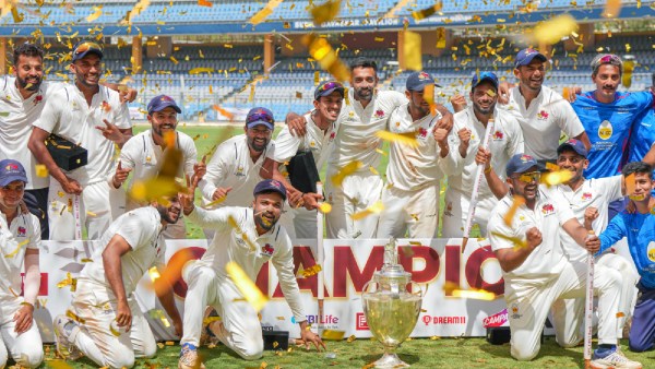 Mumbai players celebrate with the championship trophy after winning the Ranji Trophy final test cricket match between Mumbai and Vidarbha, at the Wankhede Stadium, in Mumbai. (PTI)