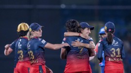 Royal Challengers Bangalore players celebrate after winning the Women's Premier League (WPL) 2024 cricket match against Mumbai Indians, at Arun Jaitley Stadium in New Delhi