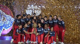 Royal Challengers Bangalore (RCB) players celebrate with the trophy after winning the WPL-T20 final cricket match against Delhi Captals at the Arun Jaitley Stadium, in New Delhi, Sunday, March 17, 2024. (PTI Photo)