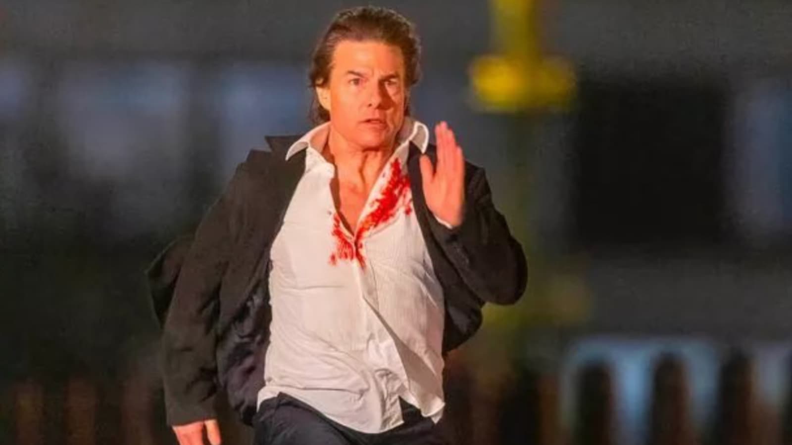 Tom Cruise runs in a blood-soaked shirt as he shoots for Mission ...