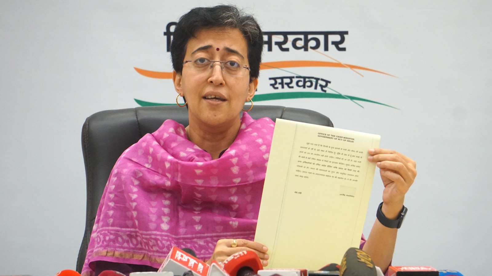 Delhi Minister and AAP leader Atishi shows Delhi Chief Minister Arvind Kejriwal's first direction from ED custody on running the city government during a press conference, in New Delhi, Sunday, March 24, 2024. (PTI Photo)