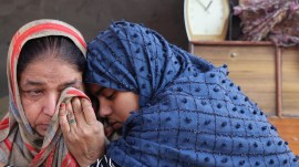 Vaqeel Hassan’s daughter Aleeza Hassan and her aunt sit outside delhi demolition