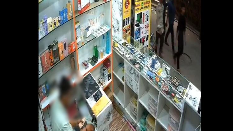 The shop owner in his shop before the attack. (