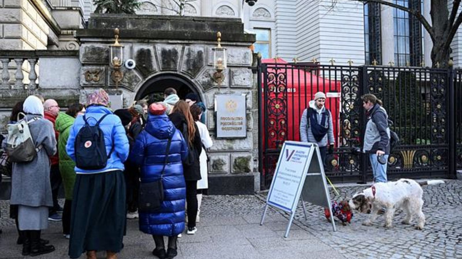 People enter the Russian Embassy on the final day of the presidential election in Russia, in Berlin, Germany.