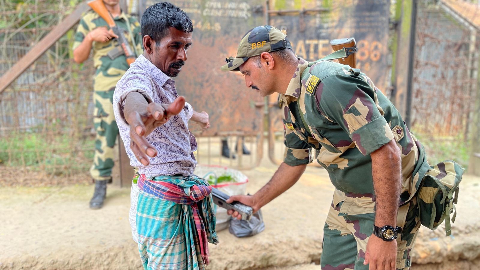 Villagers being checked by BSF jawans. (Express photo)