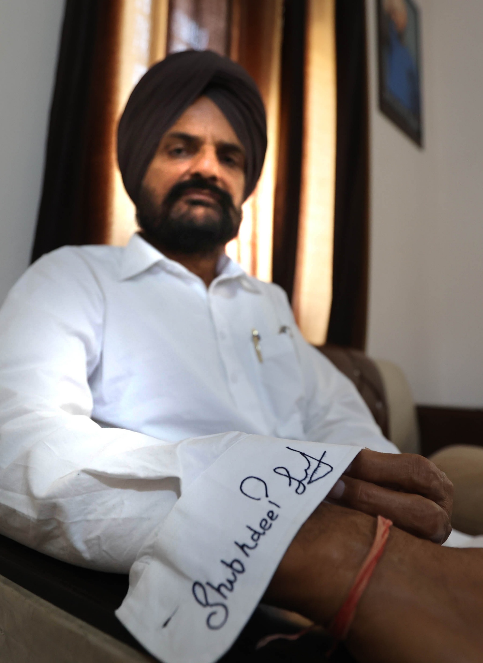 Sidhu Moosewala's father Balkaur Singh wears the Kurta with embroidery of Moosewala's signature. (Express Photo by Gurmeet Singh)