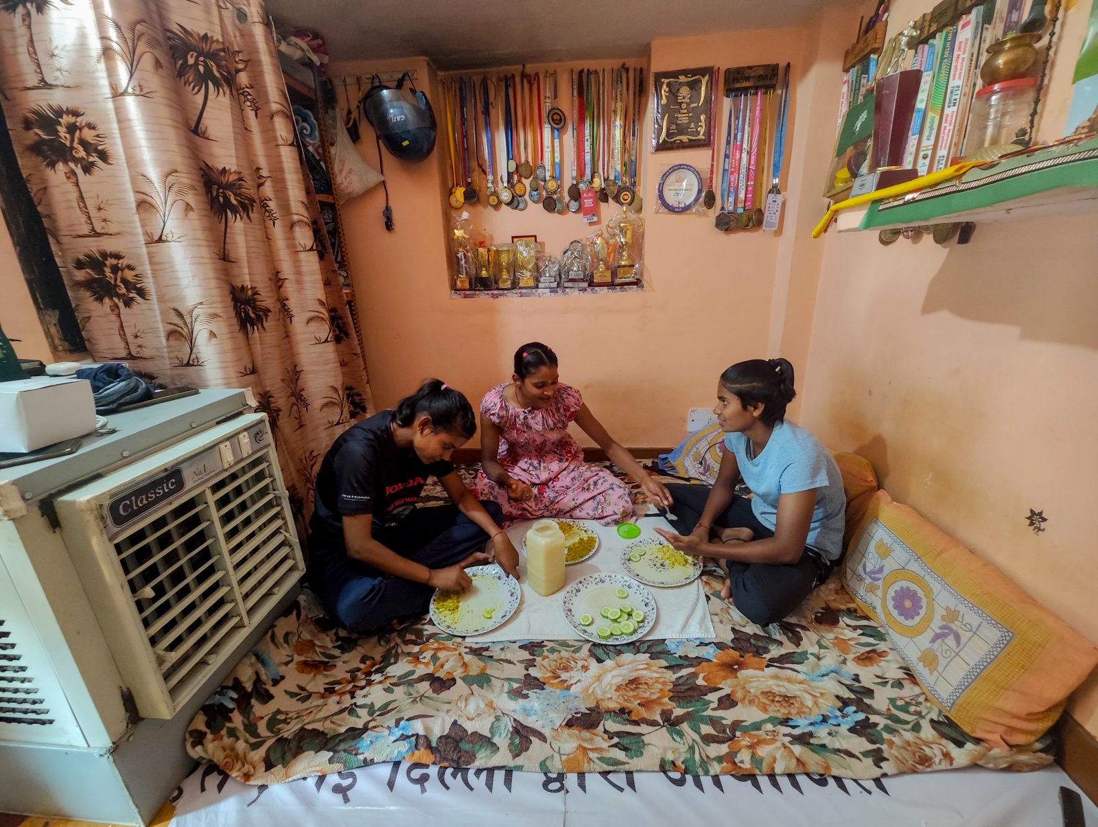 Sonam (centre), a steeplechase national record-holder from a village in Uttar Pradesh’s Bulandshahr district, in her rented room in Kotla Mubarakpur. Abhinav Saha