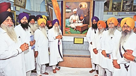 Akal Takht Jathedar Giani Raghubir Singh unveils the portrait of Allah Yaar Khan Jogi at Central Sikh Museum, in Amritsar on Tuesday.