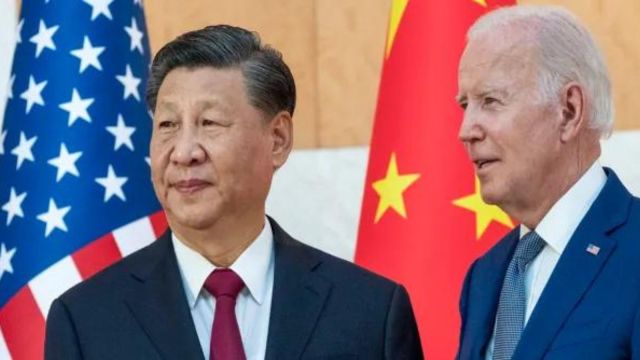 U.S. President Joe Biden, right, stands with Chinese President Xi Jinping.