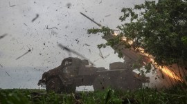 Ukrainian servicemen fire a BM-21 Grad multiple launch rocket system towards Russian troops in Donetsk region