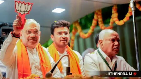 Union Home Minister Amit Shah and BJP's sitting MP from Bangalore South Tejaswi Surya during the roadshow in Bengaluru. (Express Photo)