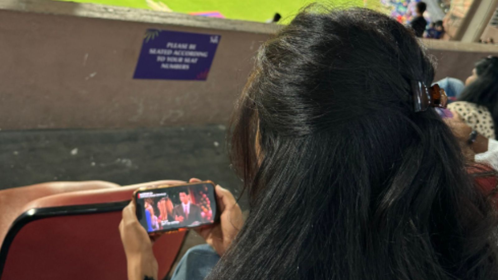 Woman watches friends during ipl match