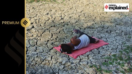 A man takes rests on the parched area of the shrunken Varuna river during a hot day in Phoolpur, some 45 km from Allahabad.