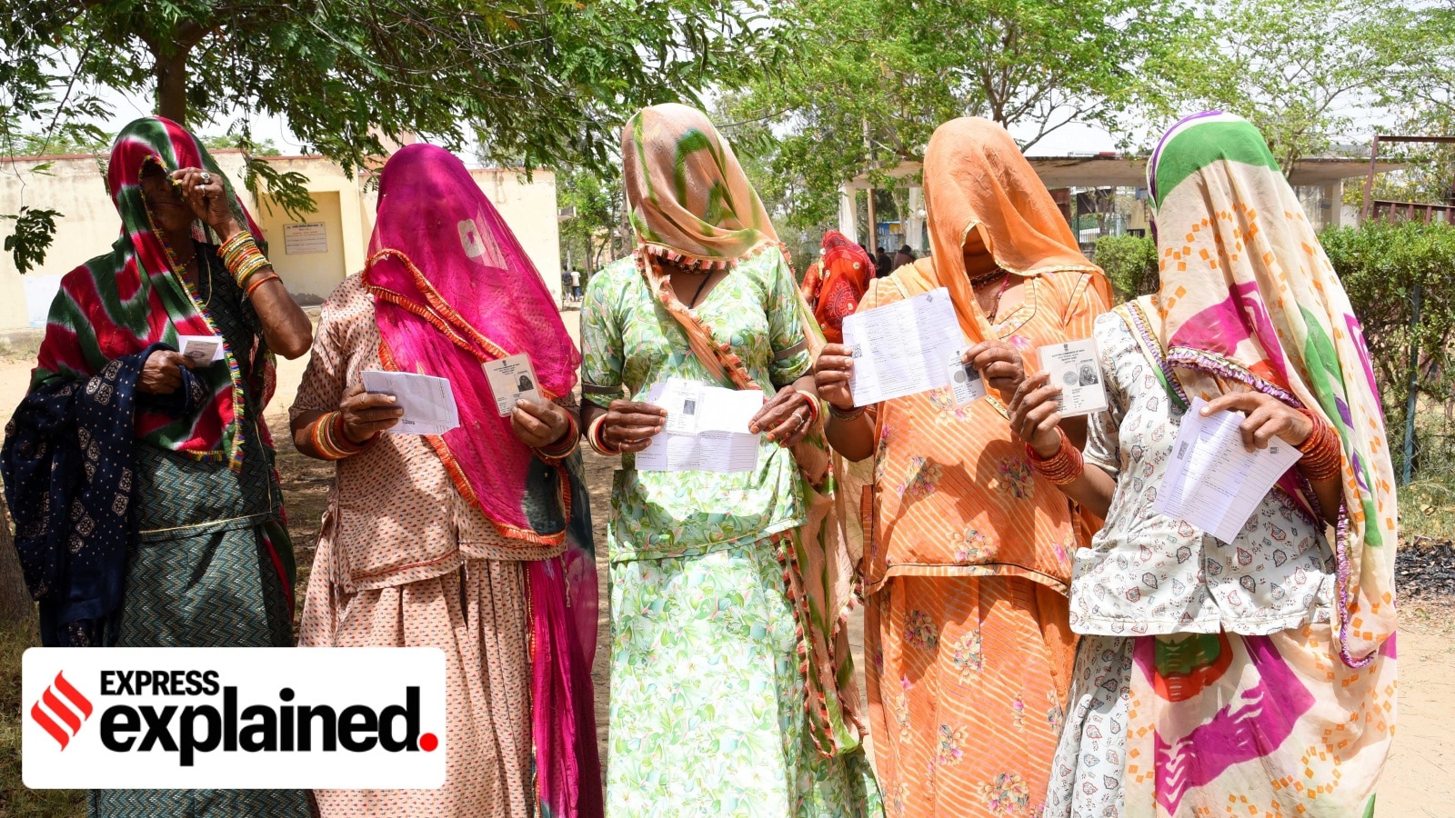 Women show their voter identity cards as they wait in queues to cast their votes during the first phase of Lok Sabha 2024 polls in Sikar, Rajasthan, on April 19.