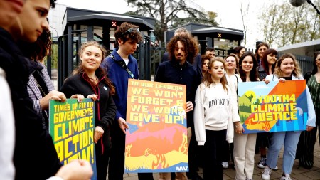 Swedish climate campaigner Greta Thunberg, the six young portuguese people, Claudia Duarte Agostinho, Martim Duarte Agostinho, Mariana Duarte Agostinho, Sofia dos Santos Oliveira, Andre dos Santos Oliveira and Catarina dos Santos Mota, and climate activists hold placards as they arrive at the court for the ruling in the climate case Duarte Agostinho and Others v. Portugal and 32 Other States, at the European Court of Human Rights (ECHR) in Strasbourg, France, April 9, 2024. REUTERS/Christian Hartmann