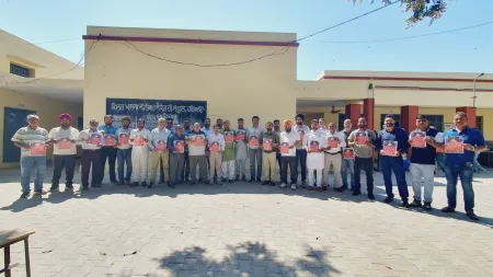 Employees with posters seeking implementation of OPS in Hoshiarpur. (Express Photo)
