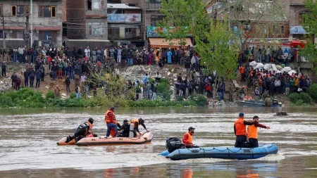 Rescuers search after a boat carrying people including children capsized in the river Jhelum in Srinagar