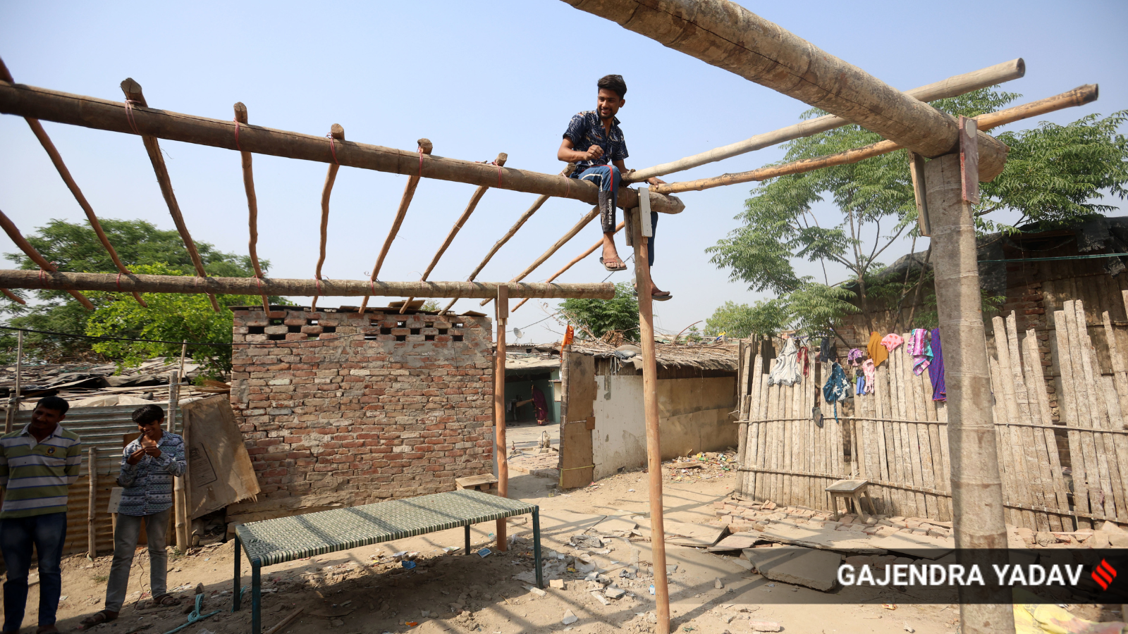 One of Dhalu Ram and his wife Dharma Devi’s two sons building a shelter for the family at Adarsh Nagar Hindu Migrants relief camp.
