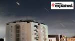 Missiles seen in the air over a building, amid Iran's strikes on Israel.