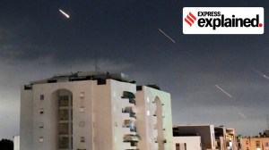 Missiles seen in the air over a building, amid Iran's strikes on Israel.