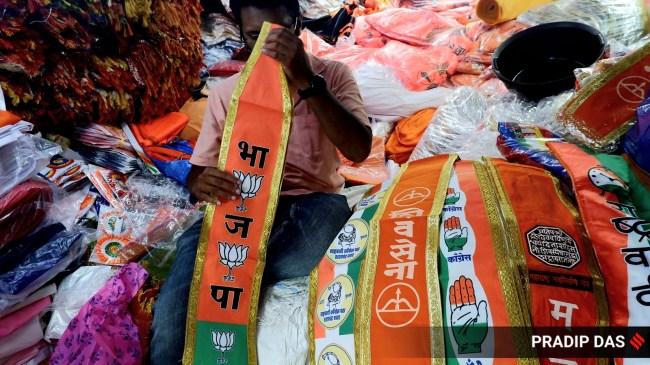 A shopkeeper in Mumbai with material showcasing different political parties' symbols, ahead of the upcoming Lok Sabha elections