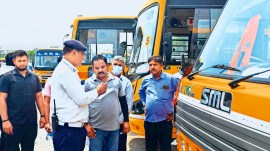 Officials check school bus fitness certificates after the Kanina school bus accident, in Gurugram on Saturday. PTI