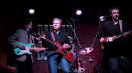 US Secretary of State Antony Blinken, center, performs "Rockin' in the Free World" with members of The 1999 band at the Barman Dictat bar in Kyiv.