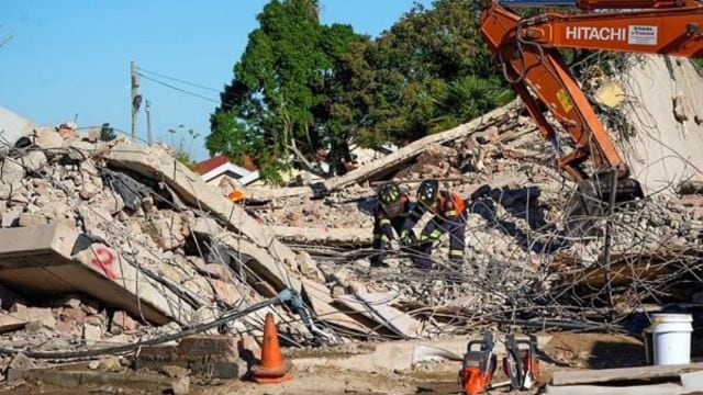 Rescue teams, searching for dozens of construction workers missing after a multi-story apartment complex collapsed in the coastal city. (AP Photo)