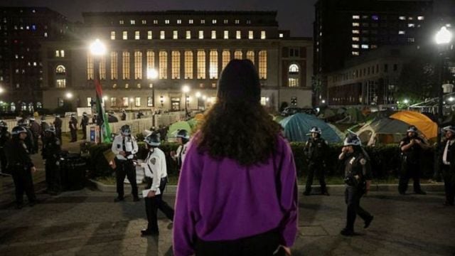 A protestor looks on as the police stand guard near an encampment of protesters supporting Palestinians on the grounds of Columbia University, during the ongoing conflict between Israel and the Palestinian Islamist group Hamas, in New York City. (Reuters Photo)