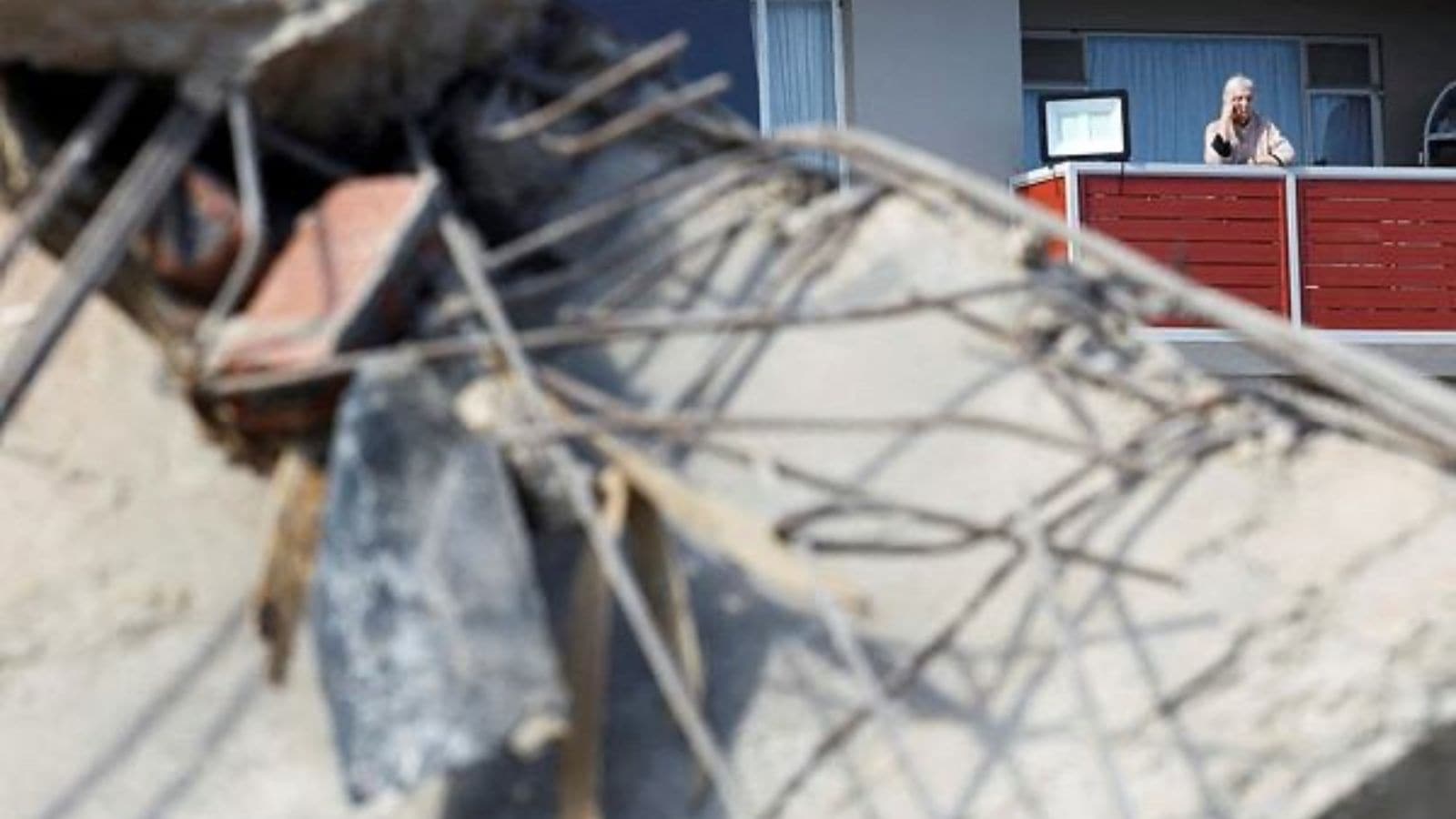  A resident watches as rescuers work to rescue construction workers trapped under a building that collapsed in George, South Africa