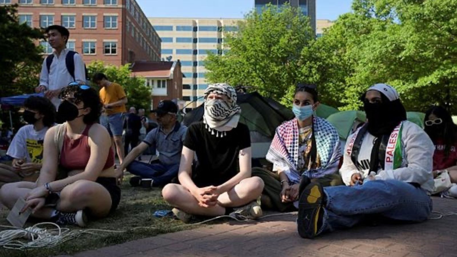 Activists listen to a speaker inside a pro-Palestinian encampment at George Washington University in Washington. (Photo by Reuters)
