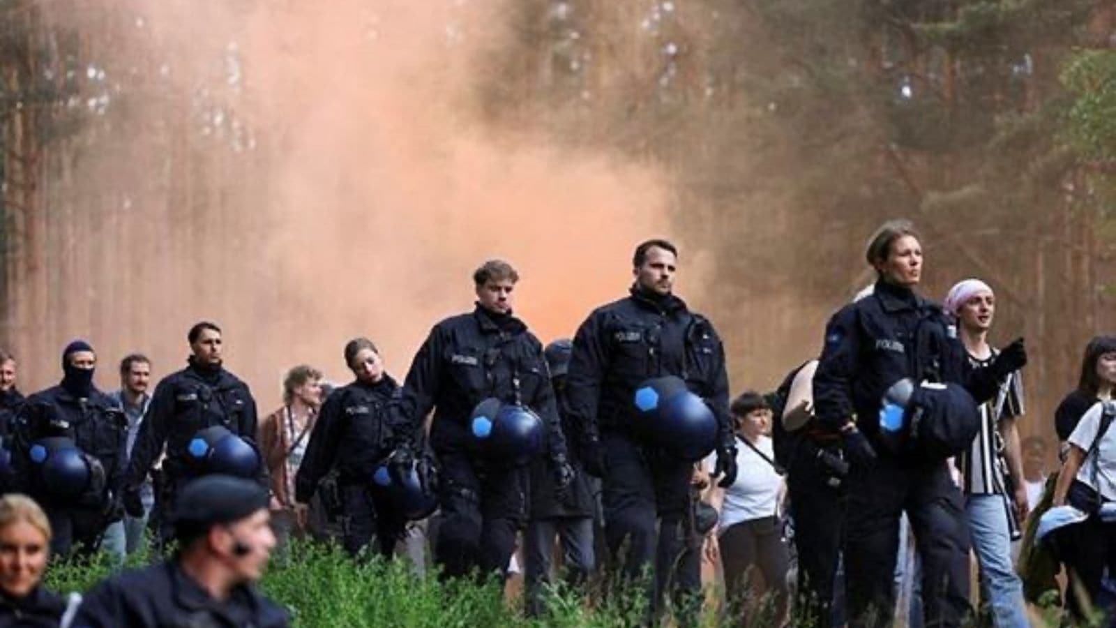 Police officers walk in line, as activists protest against the expansion of the Tesla Gigafactory in Gruenheide near Berlin, Germany. (Reuters Photo)