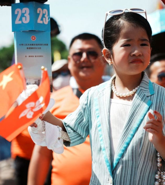 A child is dressed up as Hong Kong's legislator Regina Ip during the Bun Festival parade. (Reuters Photo)