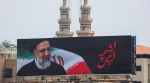 An image of late Iranian President Ebrahim Raisi who was killed along with other officials in a helicopter crash, is displayed on a hoarding in Beirut suburbs, Lebanon