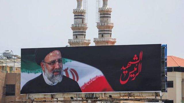 An image of late Iranian President Ebrahim Raisi who was killed along with other officials in a helicopter crash, is displayed on a hoarding in Beirut suburbs, Lebanon