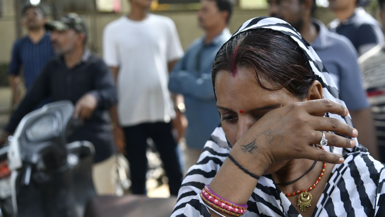 Rajkot Fire Live Updates: Relatives and friends of the victims of the gaming zone fire gathered outside the Rajkot Civil Hospital on Sunday morning, anxiously waiting for an update on their dear ones. (Express photo by Chirag Chotaliya)