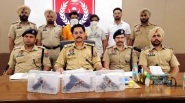 Patiala police personnel with recovered weapons from Bishnoi gang members. Express