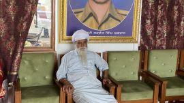Satwant Singh’s portrait looms large as Gurnam sits in a room in a memorial, which the family has built on the Kalanaur-Dera Baba Nanak highway in their village Agwan.