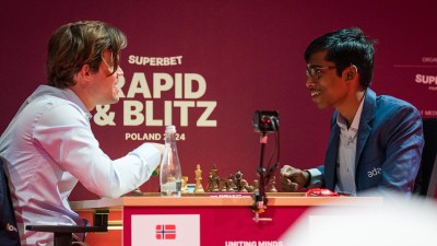 Magnus Carlsen talks to Praggnanandhaa after their match at the 2024 Superbet Rapid & Blitz Poland. (PHOTO: Courtesy of Grand Chess Tour/Lennart Ootes)